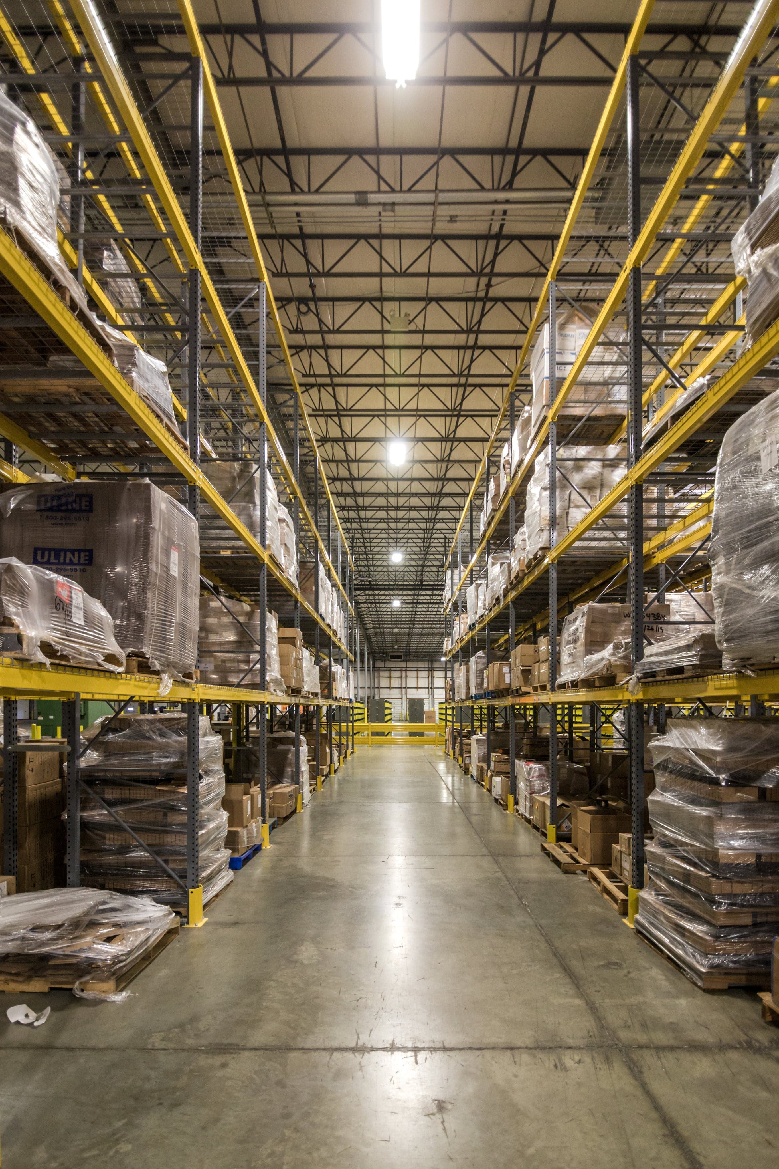 Warehouse corridor representing wholesale distribution and fulfillment.